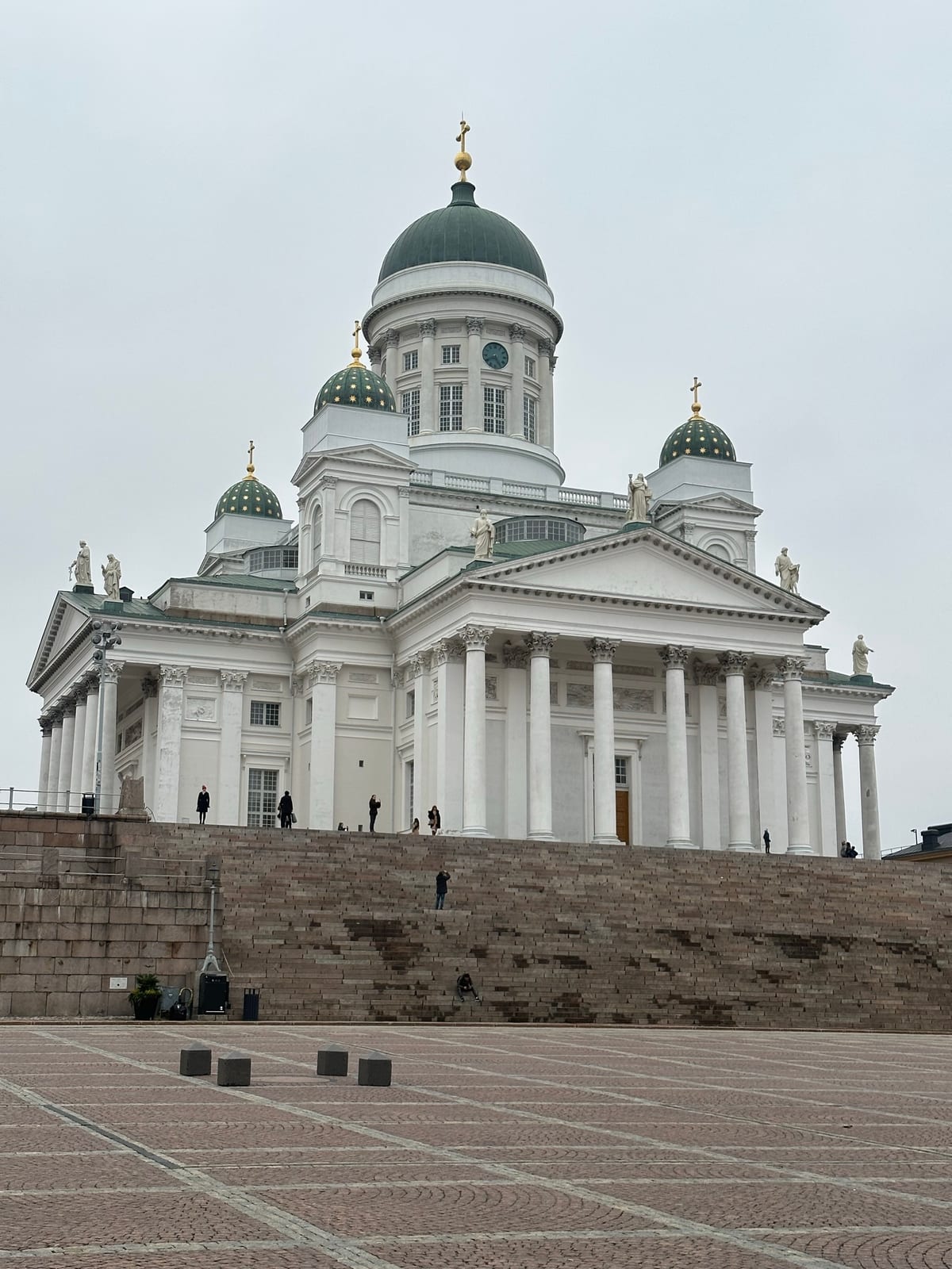 The Helsinki Cathedral - a tall, white palace with green domed roofs decorated with golden stars