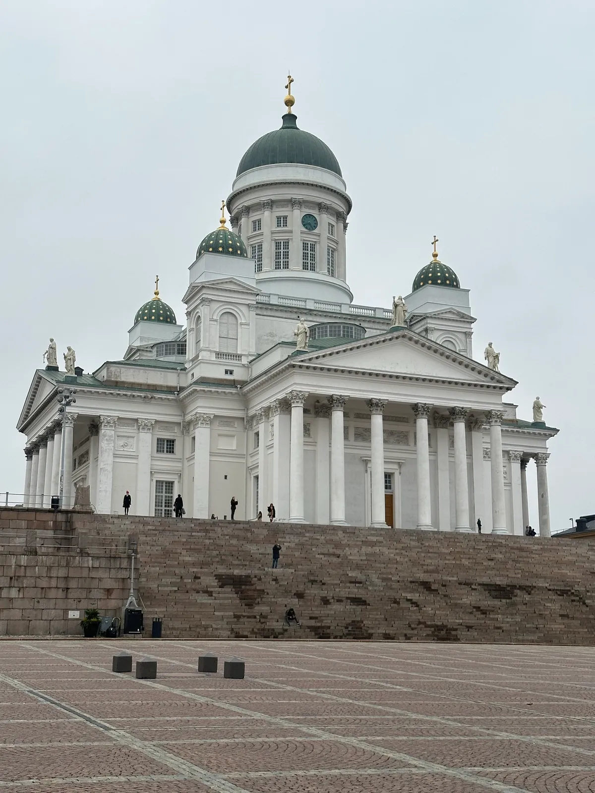 The Helsinki Cathedral - a tall, white palace with green domed roofs decorated with golden stars