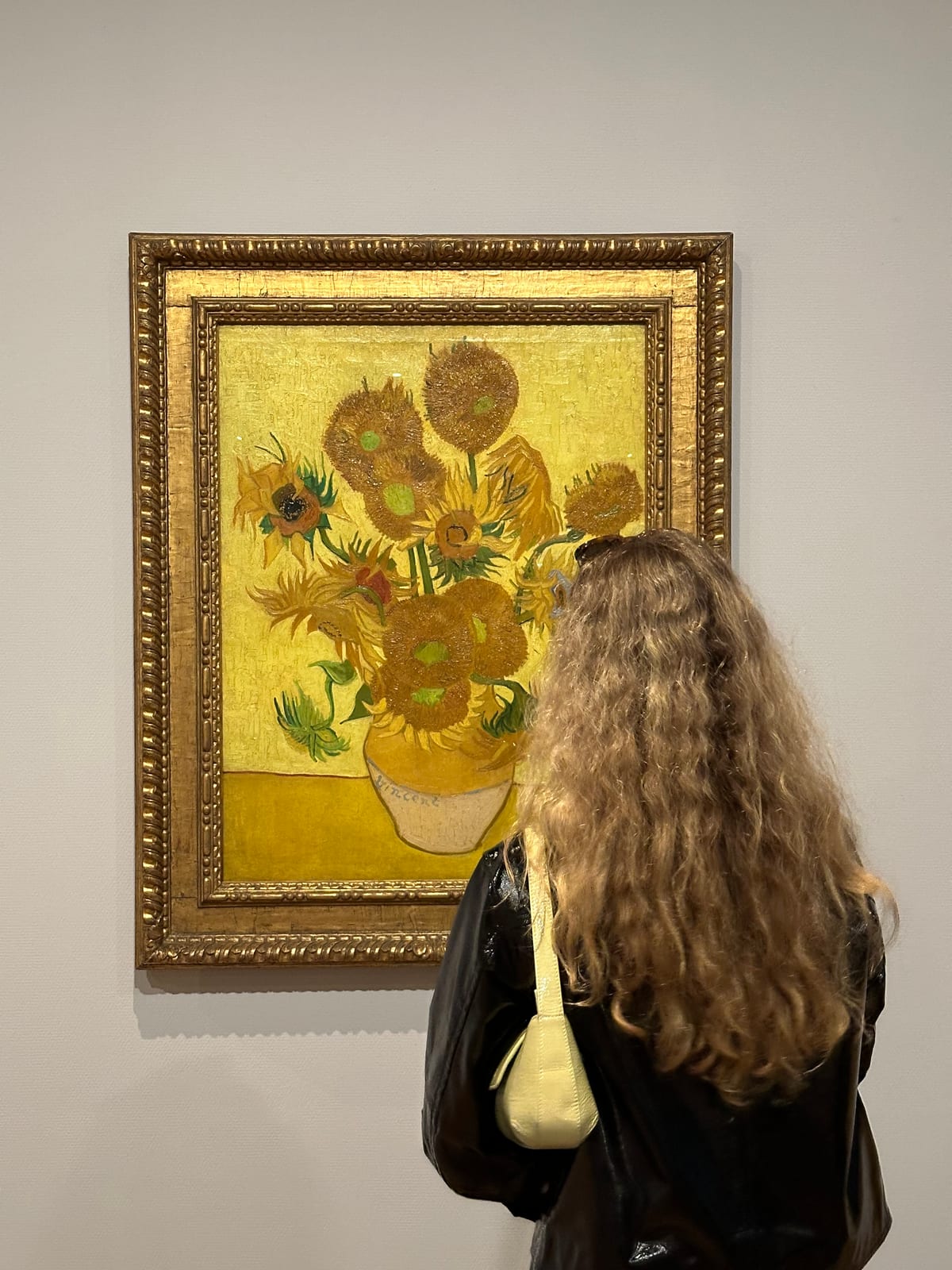 My girlfriend in front of the sunflowers by Van Gogh