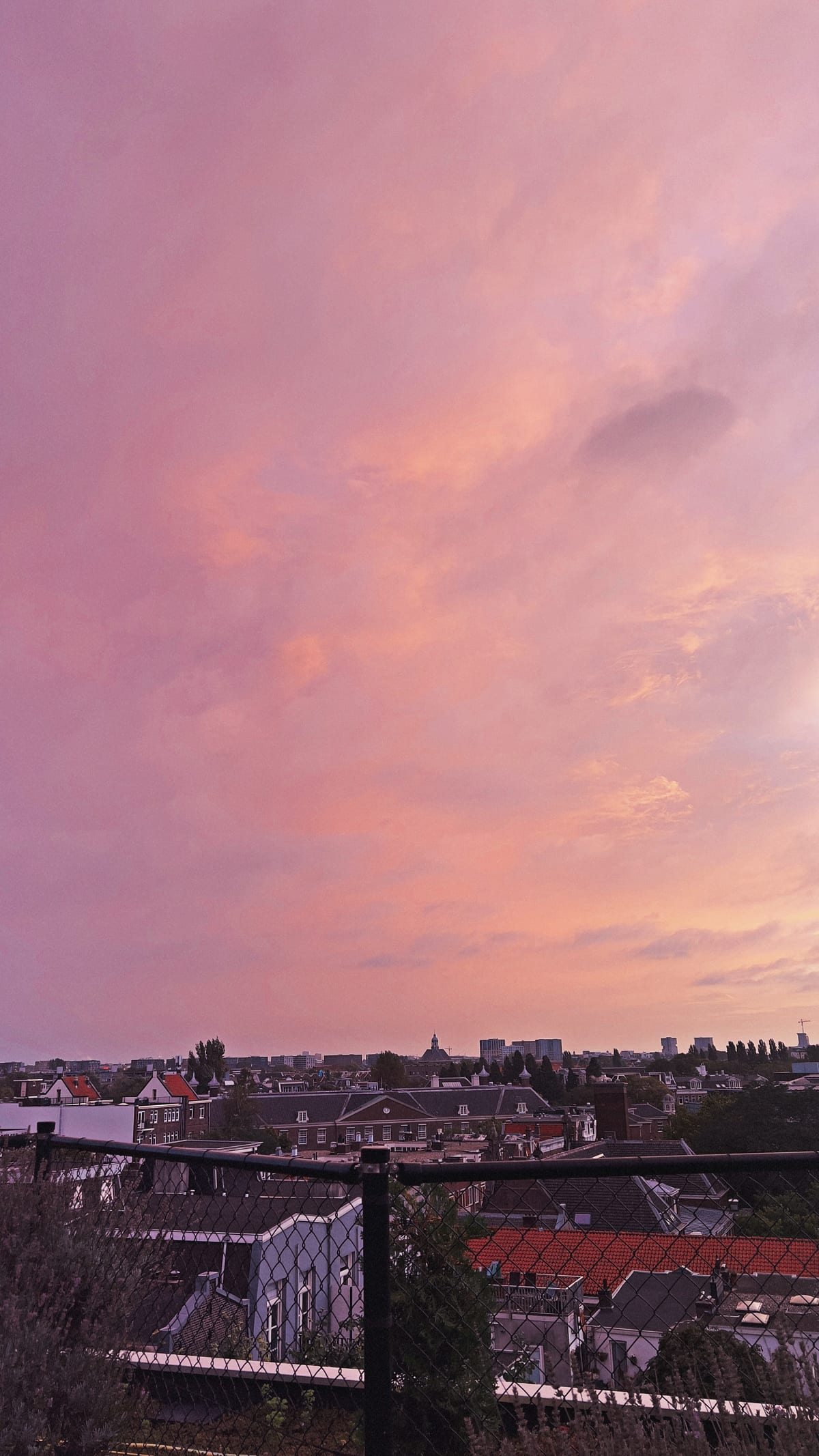 The sunset over Amsterdam as seen from the rooftop lobby of the Zoku hotel