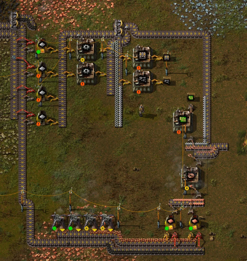The same factory as before, but built with expansion in mind. Production of raw resources and parts is centralized and then the resources are carted around the factory on conveyor belts. There is plenty room to add more machines or expand existing ones.